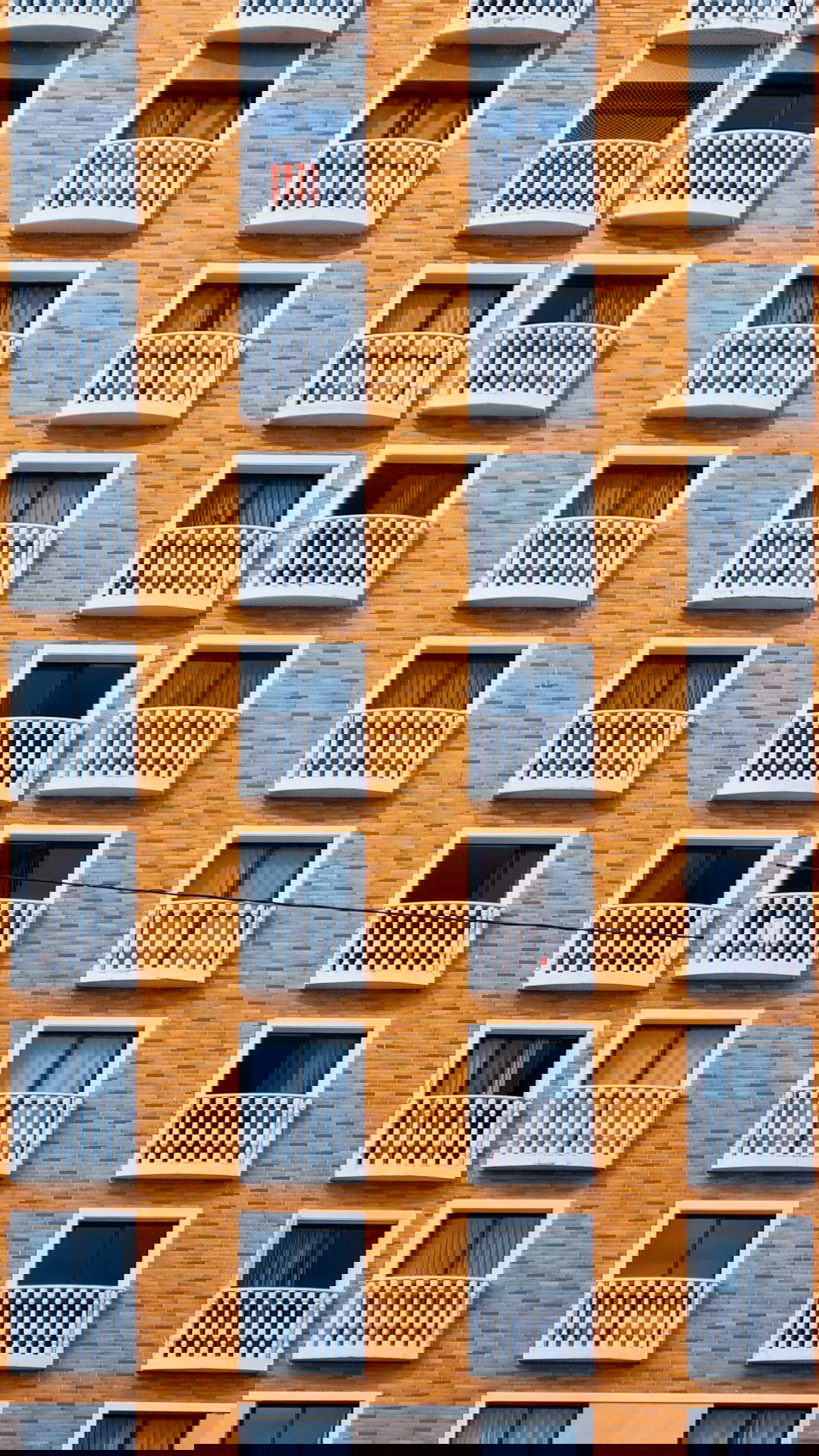 a tall brick building with balconies and balconies